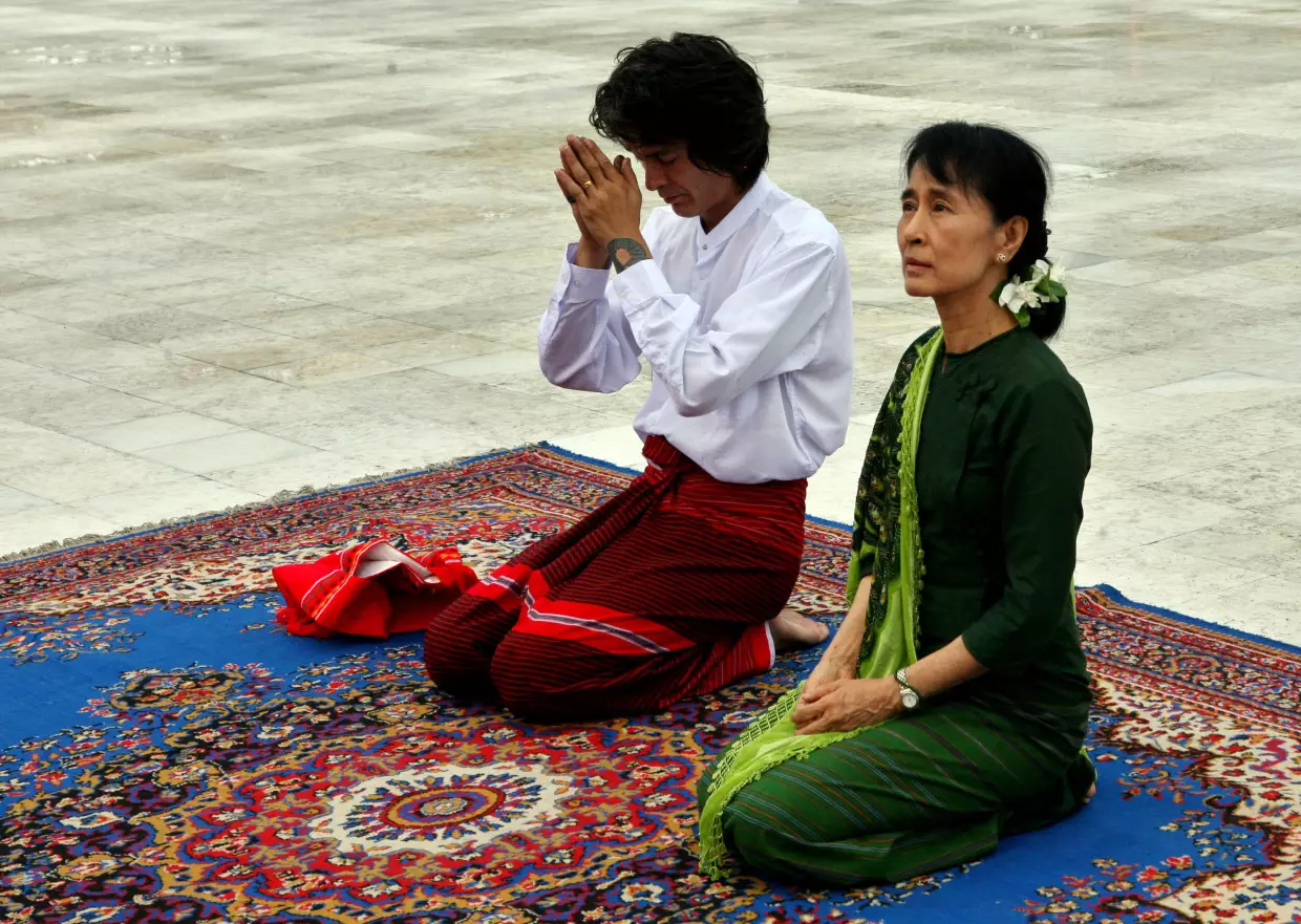 Aung San Suu Kyi, right, and her youngest son Kim Aris pay respect to the late Gen. Aung San, father of Suu Kyi, at the Martyr's Mausoleum in Yangon, Myanmar, Tuesday, July 12, 2011.