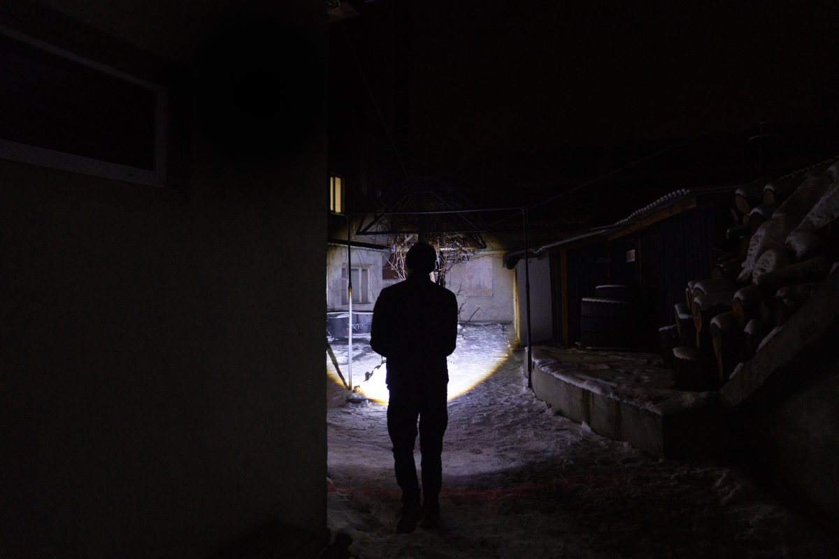 Lohinov uses a flashlight just to walk from one building to another at night in the fire station.