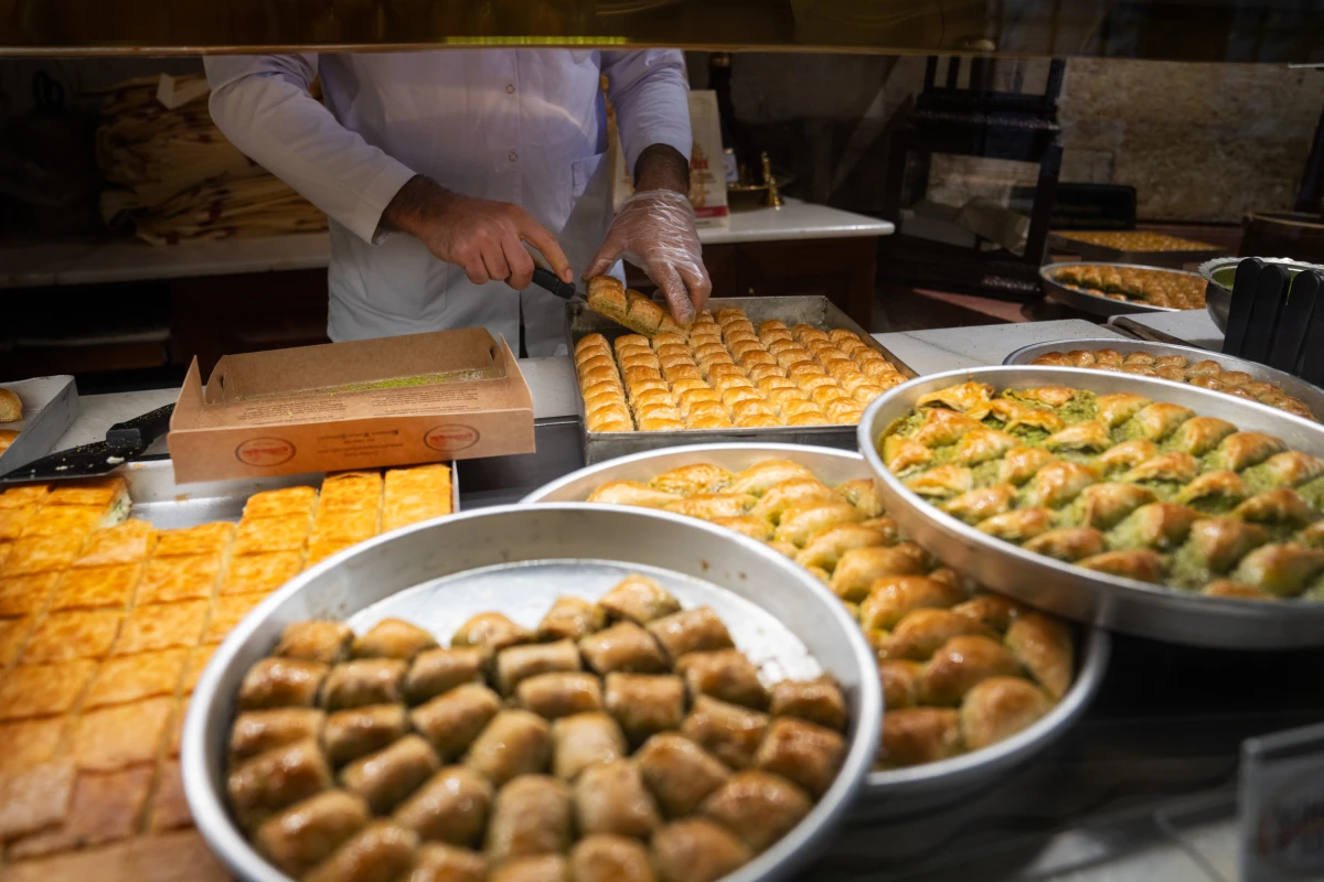Different types of baklava are on display and being packaged at Gulluoglu, a shop in Gaziantep, Turkey. The city has many shops dedicated to the sweet pastry.
