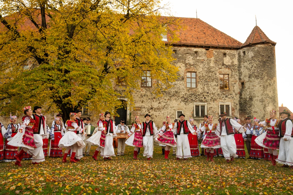 The Transcarpathian Folk Choir performs a song and dance for a music video that they are working on to share their music. Ukraine's St. Miklos Castle, which is now an arts exhibit space, a meeting place and museum for local history, provides the backdrop.