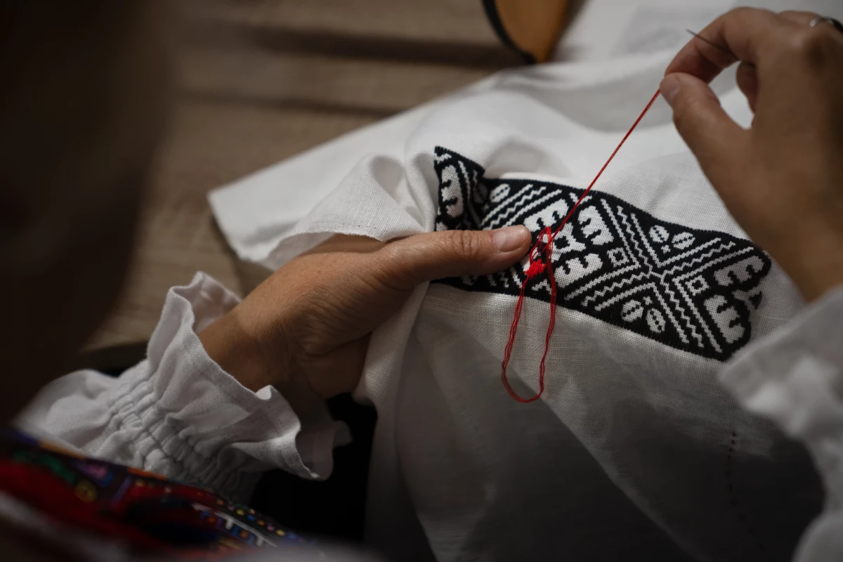 Hanna Haiduk uses a needle and thread to form intricate designs, many of which she copies from historical works she finds in books or those she saved from her family's past work.