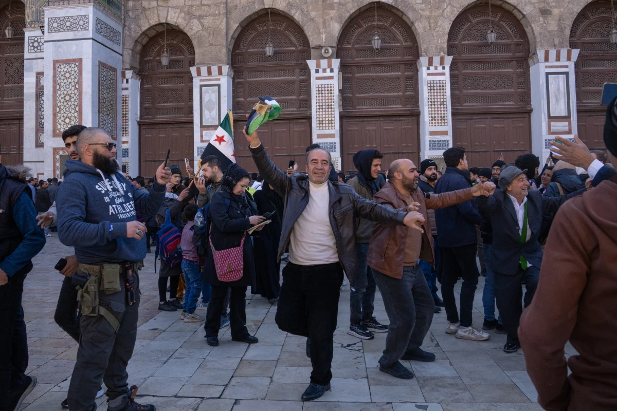 Men dance outside the Ummayad Mosque in Damascus, Syria, on Friday.