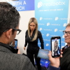 FILE - A Realbotix humanoid robot, center, speaks with attendees at a Realbotix booth during the CES tech show Jan. 8, 2025, in Las Vegas.
