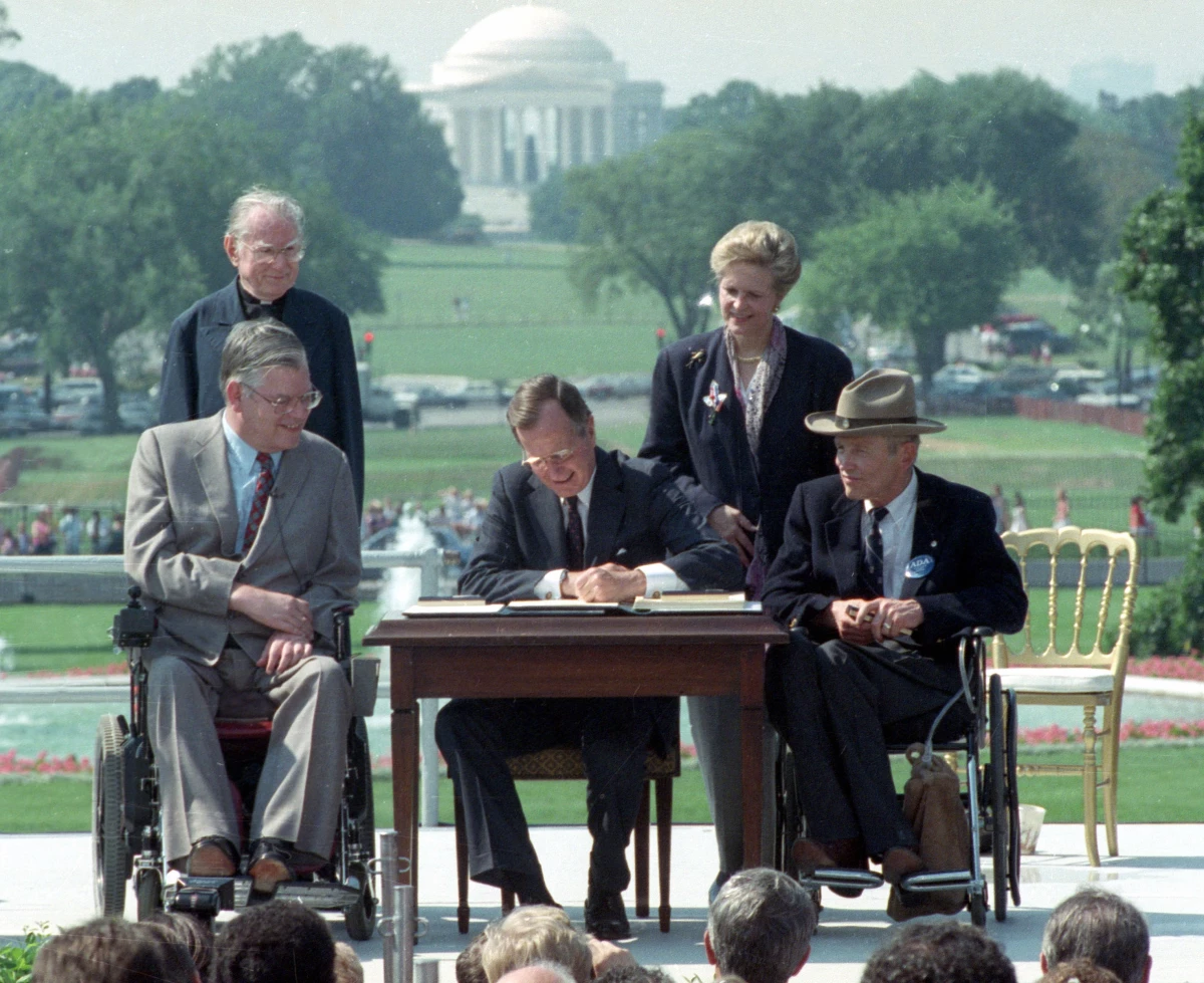 'Let the shameful wall of exclusion finally come tumbling down,' President George H. W. Bush said as he signed the Americans with Disabilities Act into law at a White House ceremony on July 26, 1990. The law said hotels and other public place must be made accessible to people with disabilities.
