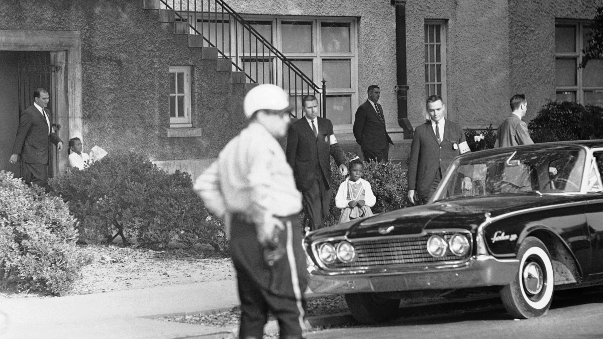 Six-year-old Leona Tate is escorted by U.S. Marshals from McDonogh 19 Elementary School in New Orleans on Nov. 15, 1960.