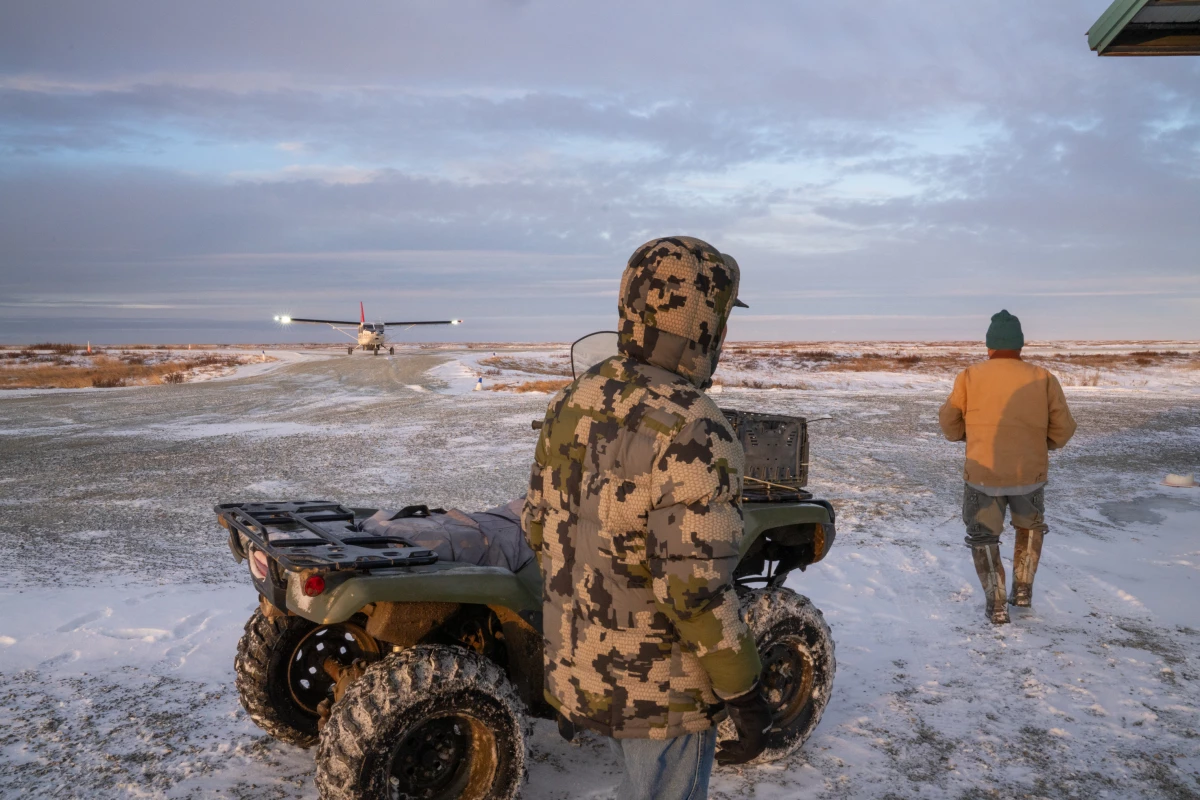 People wait for a plane to arrive in Kwigillingok.
