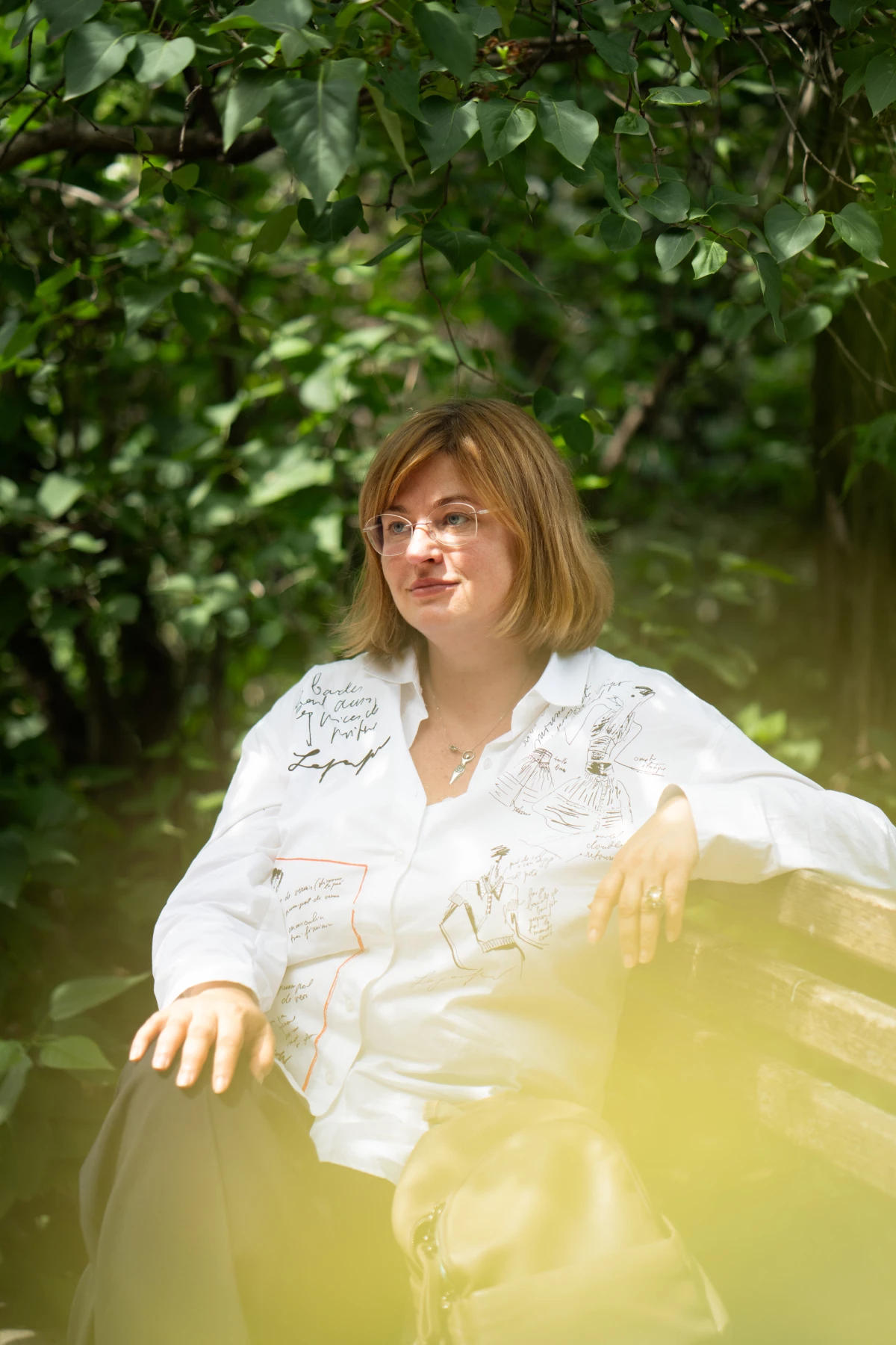 Schestova sits on a park bench in central Kyiv near her apartment. She says she loved Romania's capital, Bucharest, where she fled to after Russia's full-scale invasion of Ukraine, and even convinced friends to join her there. But in the end, she decided to return to Kyiv.