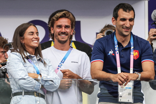 Athletico Madrid's French football player Antoine Griezmann, his wife Erika Choperena, and French Rugby Federation CEO Jeremie Lecha attend the men's gold medal rugby sevens match between France and Fiji during the Paris Olympics the Stade de France in Saint-Denis last month.