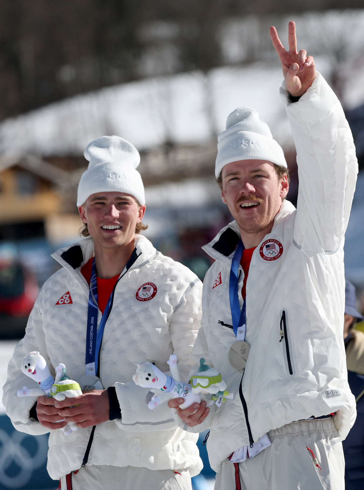 The silver-medal celebration for the U.S. at the men's team cross country free sprint: Gus Schumacher, left, and Ben Ogden.