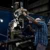 Apprentice Caleb Moss uses high-precision machinery at Virco Manufacturing in Conway, Ark.
