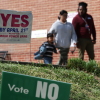 Voters depart after casting their ballots at a polling location at the Westover Library on April 21, in Arlington, Va.