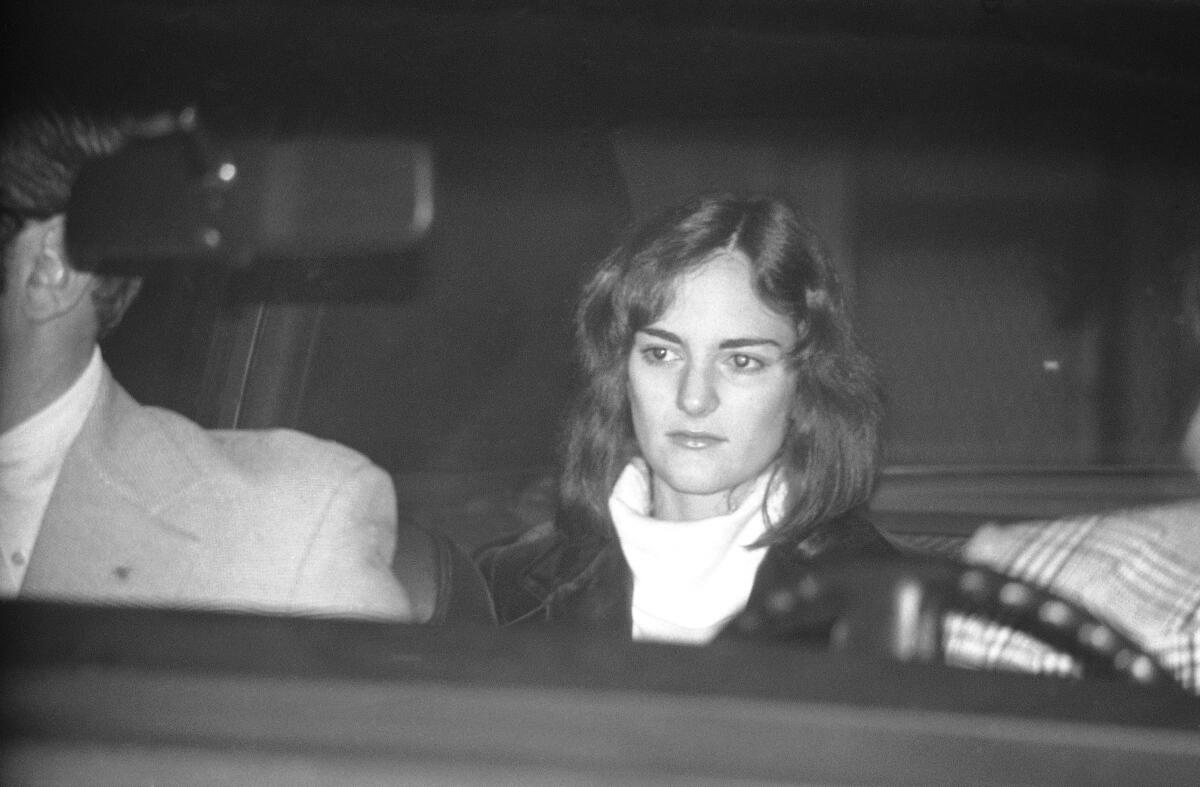 Patty Hearst is seated in a U.S. Marshal's car, leaving the San Mateo County jail in Redwood City, Calif., on Dec. 12, 1975, on her way to San Francisco to an appearance in federal court. Hearst, the granddaughter of newspaper publisher and politician William Randolph Hearst, was tried and convicted on bank robbery charges in 1976, which were later commuted by President Jimmy Carter.