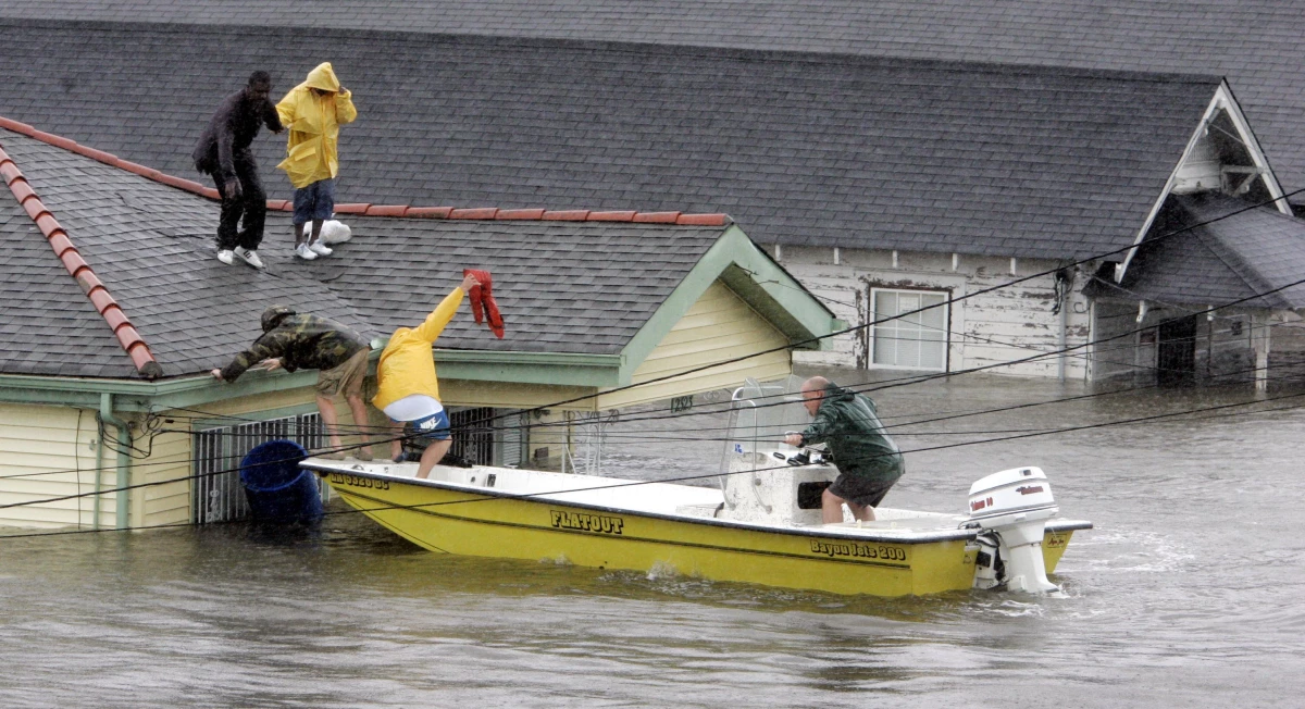 Bryan Vernon and Dorothy Bell are rescued from their rooftop after Hurricane Katrina hit, causing flooding in their New Orleans neighborhood on Aug. 29, 2005.