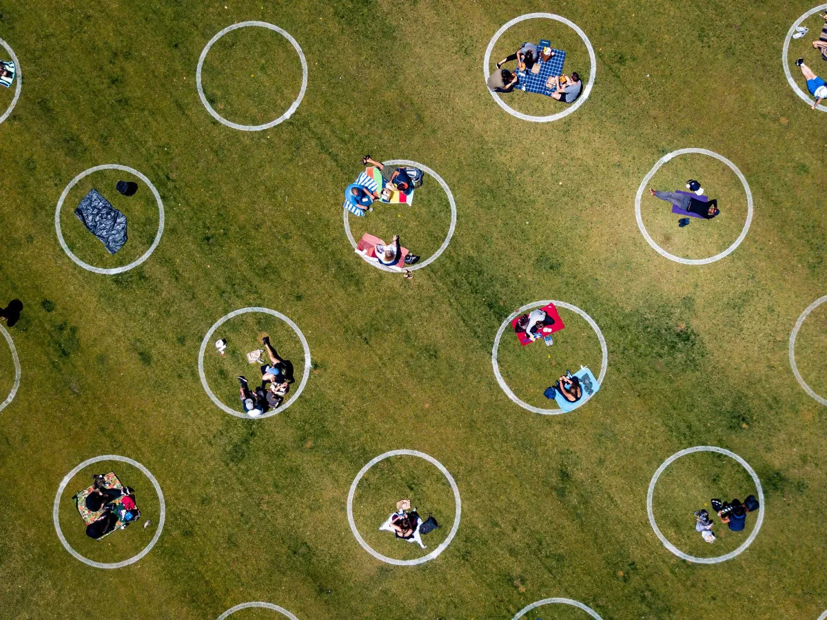 An aerial view shows painted circles in the grass to encourage people to keep a distance from each other at Washington Square Park in San Francisco. The photo is from May 22, 2020.
