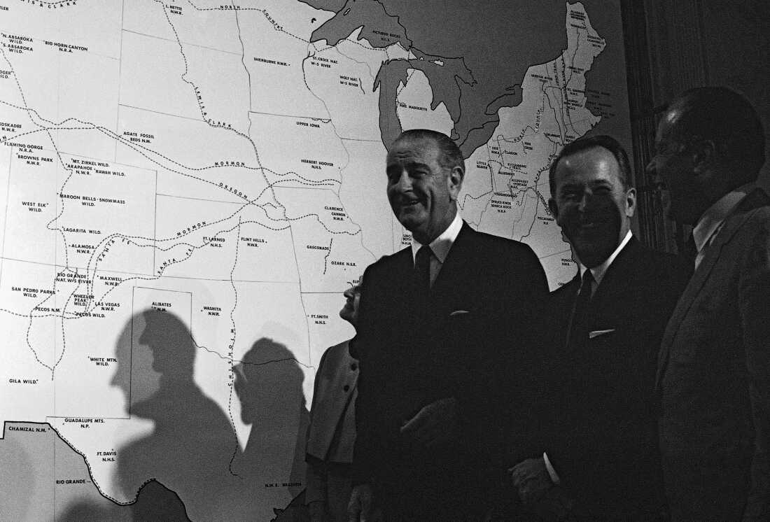 President Lyndon Johnson stands near a map of the U.S. after signing several conservation bills into law in 1968.