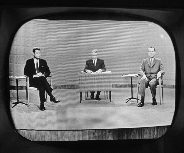 Moderator Howard K. Smith sits between, Sen. John Kennedy (left) and Vice President Richard Nixon as they appear on a television studio monitor during their debate in Chicago on Sept. 26, 1960.