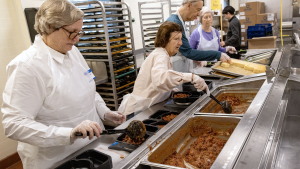 Volunteers prepare food at Community Servings, a Boston nonprofit that produces medically-tailored meals.
