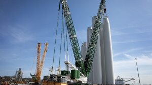 A crane stacks turbine components at the New London State Pier Terminal. (Robin Lubbock/WBUR)