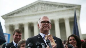 Plaintiff Jim Obergefell holds a photo of his late husband John Arthur as he speaks to members of the media after the U.S. Supreme Court handed down a ruling regarding same-sex marriage June 26, 2015, outside the Supreme Court in Washington, D.C. The high court ruled that same-sex couples have the right to marry in all 50 states.