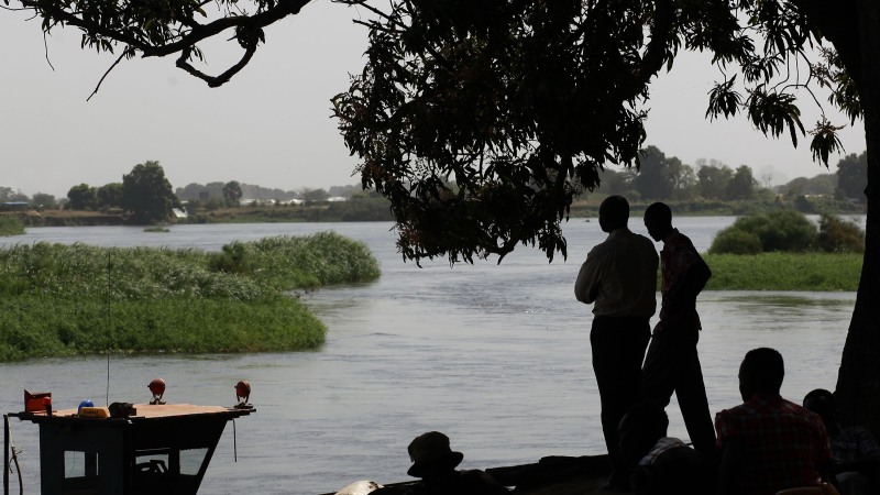 Southern Sudanese who have returned to the south by barges stand on the banks of the Nile river in Juba's port on Jan. 10, 2011.
