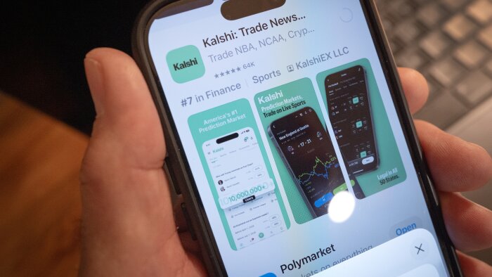 An app for Kalshi, an online prediction market site, is shown on a phone. Multiple states have tried to block the company from operating, citing state gambling laws. But the federal government has sued to block those state laws to allow Kalshi and other prediction markets to operate.