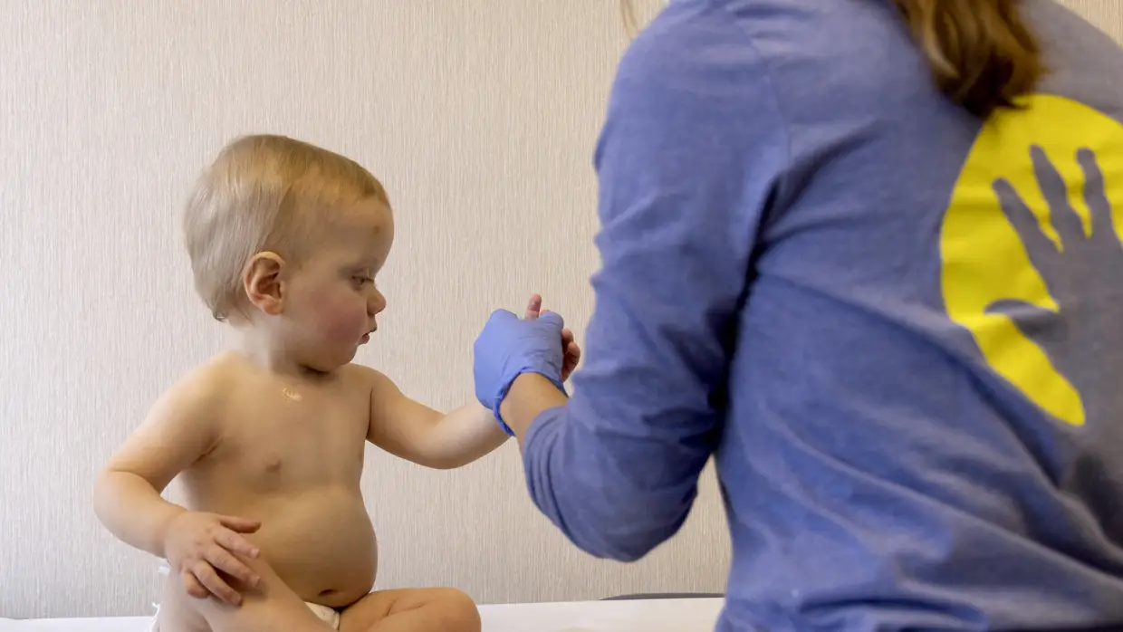 A child is prepped to receive an MMR vaccine at Lurie Children's Primary Care in Chicago.