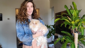 Susan Burke is trying to sell tickets on StubHub, but they are not showing up for most users. Here, Burke is posing with her cat, Peaches.