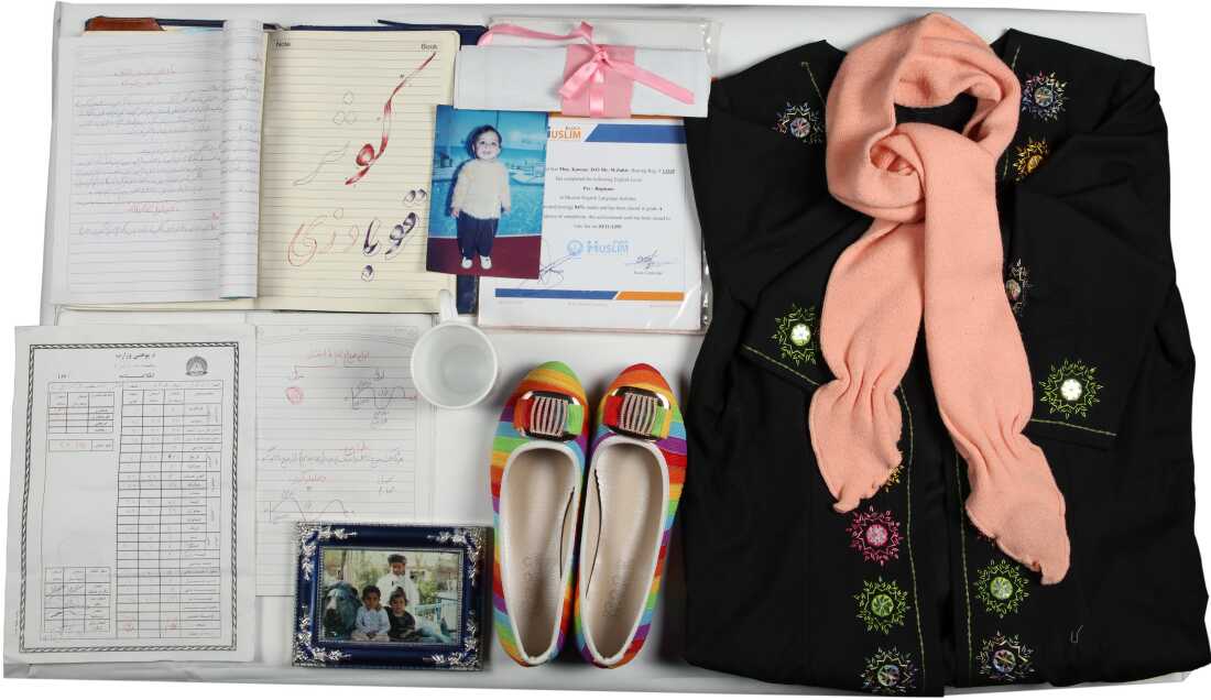 The Afghanistan Memory Home Museum creates "memory boxes" with personal belongings and photographs and documents for those who suffered or died in the country's conflicts. This memory box memorializes Kawsar Qubadian and includes her sweater and slippers.
