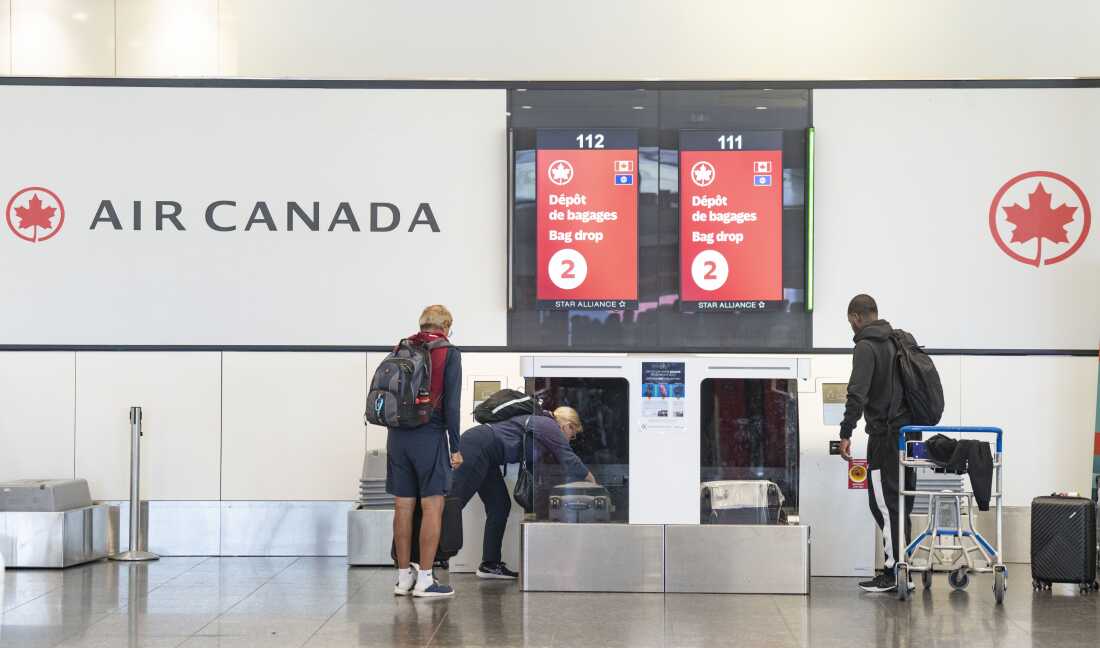 Air Canada travellers load their luggage at Montreal-Pierre Elliott Trudeau International Airport on Tuesday.