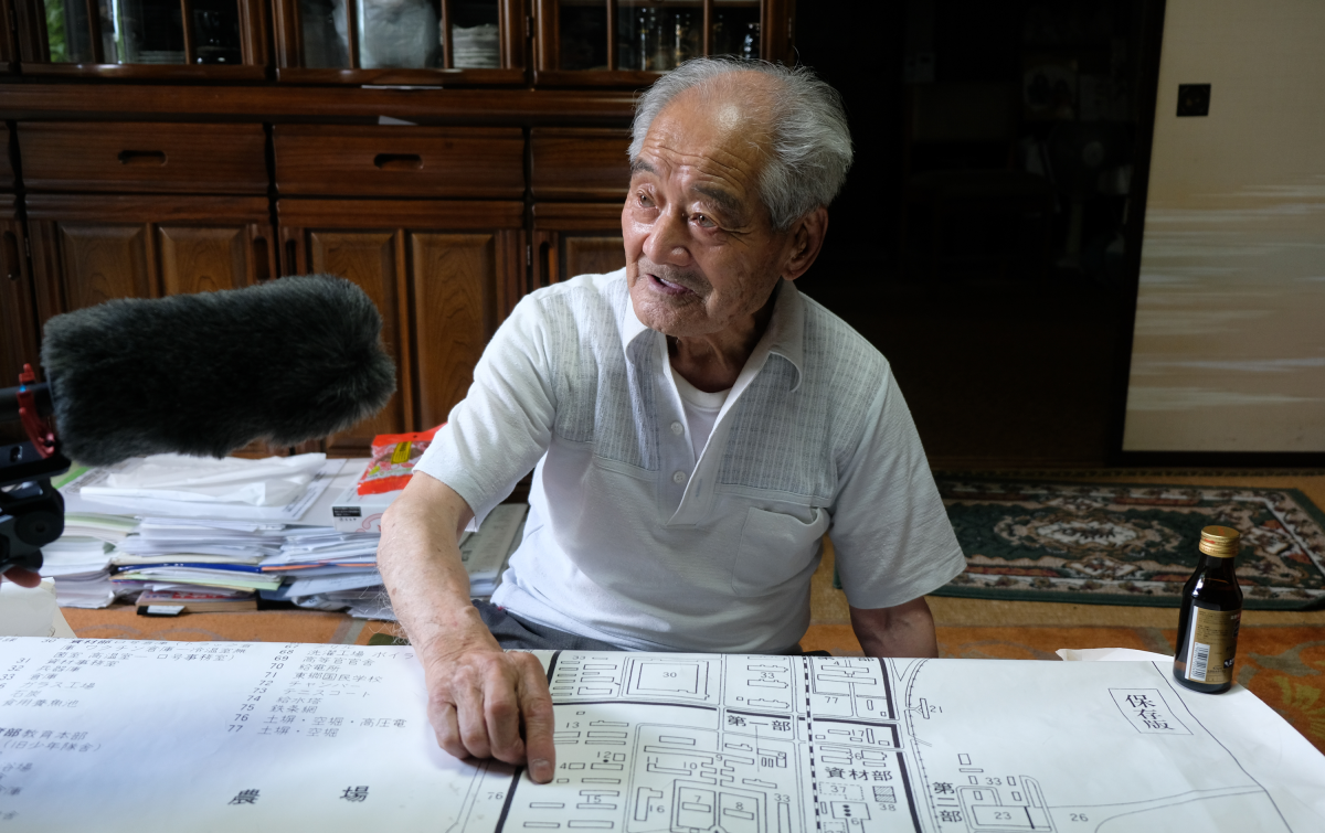 Former Unit 731 Youth Corps member Hideo Shimizu, 95, speaks during an interview at his home in Nagano prefecture, Japan, while pointing to a map of his former unit's headquarters in northeast China.