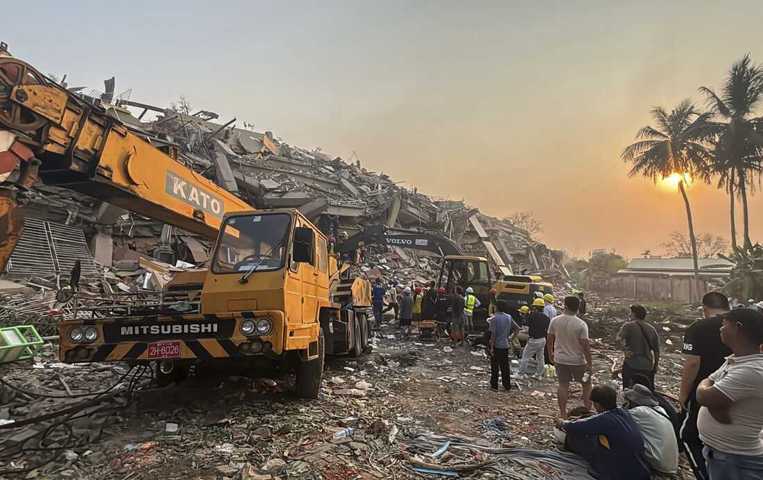 Rescuers work with the help of heavy machinery at the Sky Villa Condo that collapsed In Friday's earthquake in Mandalay, Myanmar on Sunday.