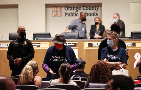 Women wearing "Moms for Liberty" shirts attend the Orange County Public School Board Meeting in Orlando, Fla., on Oct. 26, 2021.