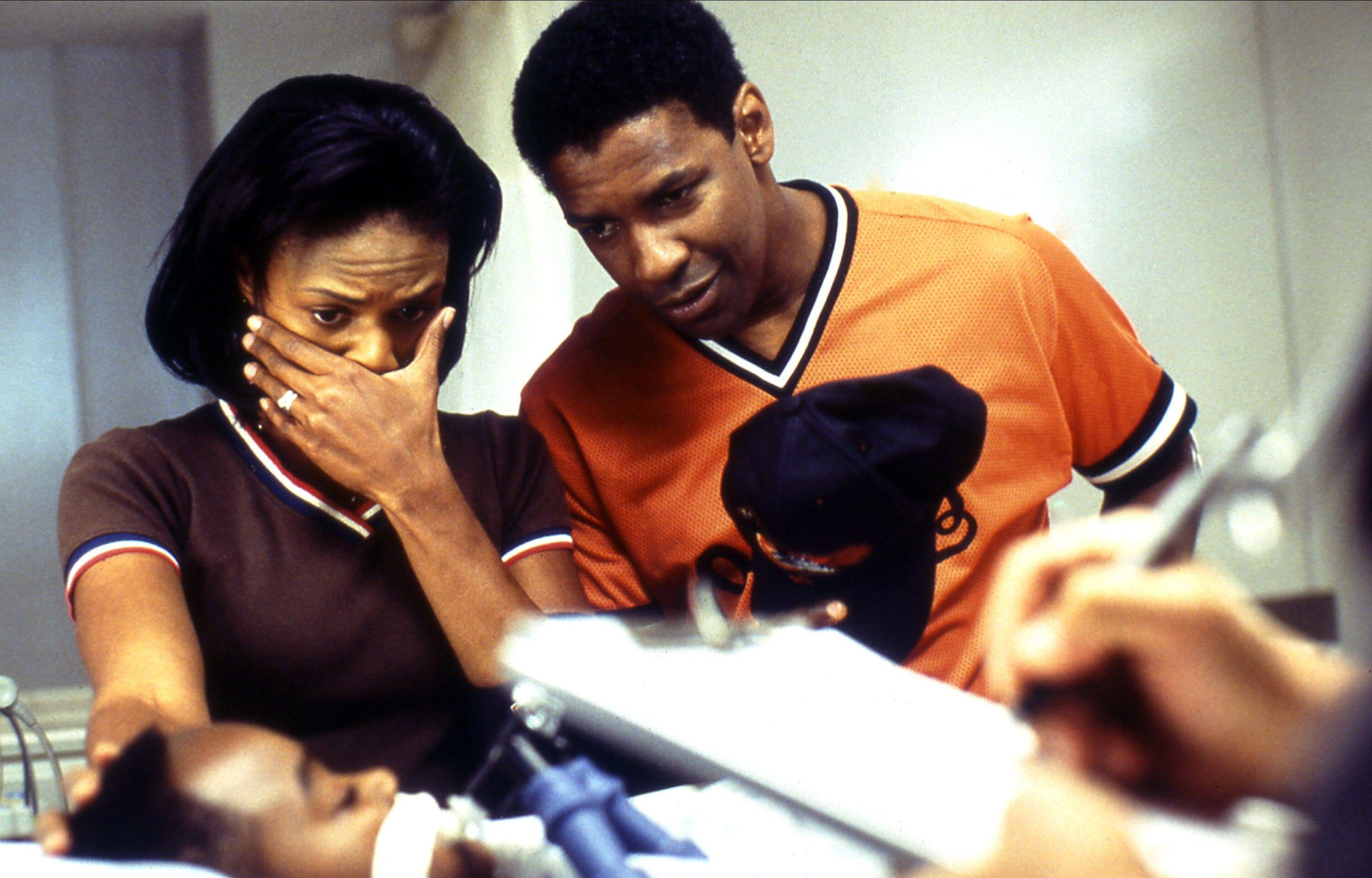 In the 2002 medical thriller <em>John Q, </em>Denzel Washington and Kimberly Elise play parents who learn that their 9-year-old son
