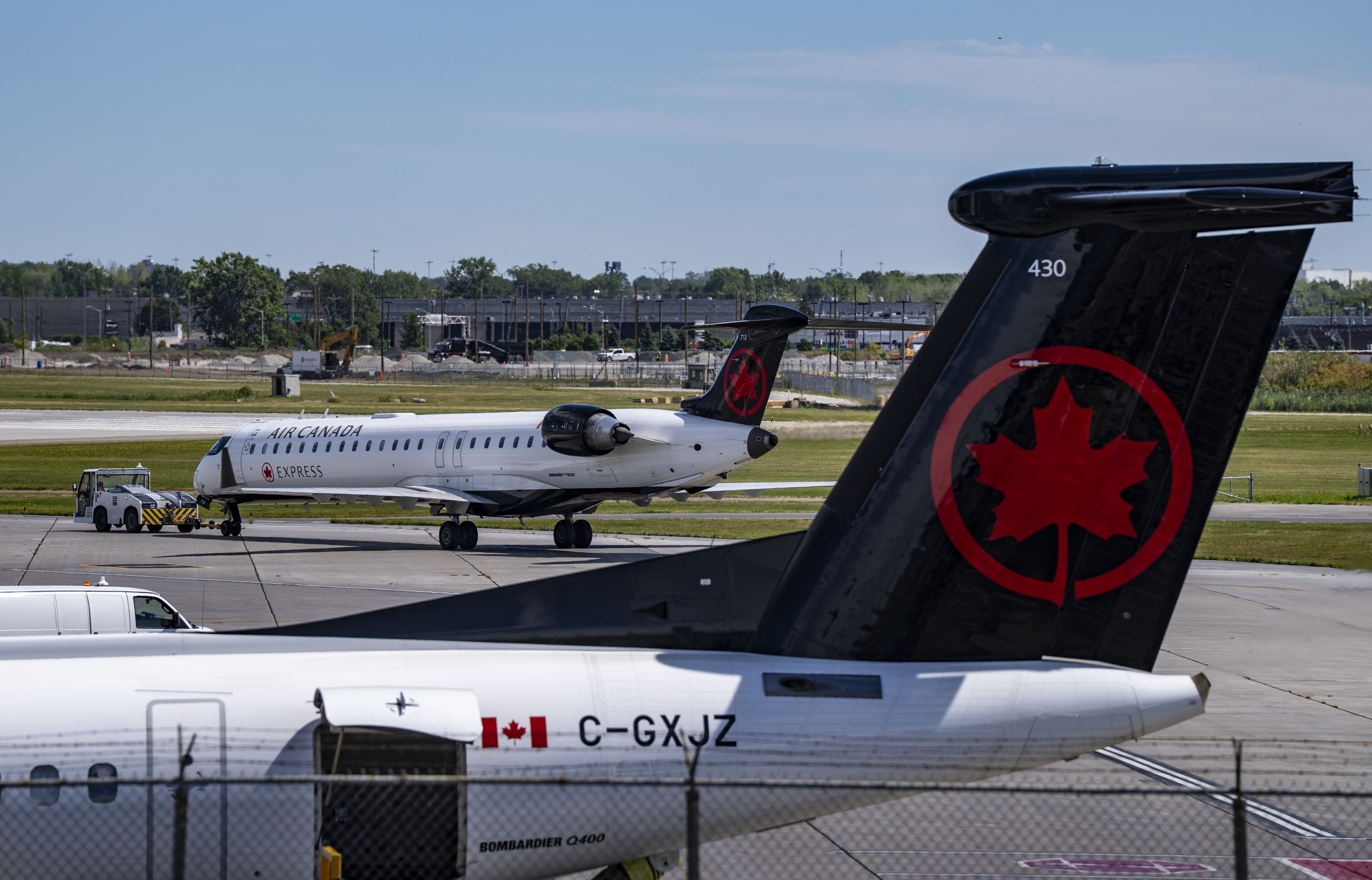 An Air Canada plane gets a pushback from its gate at Montreal-Pierre Elliott Trudeau International Airport in Dorval, Quebec, on Tuesday.