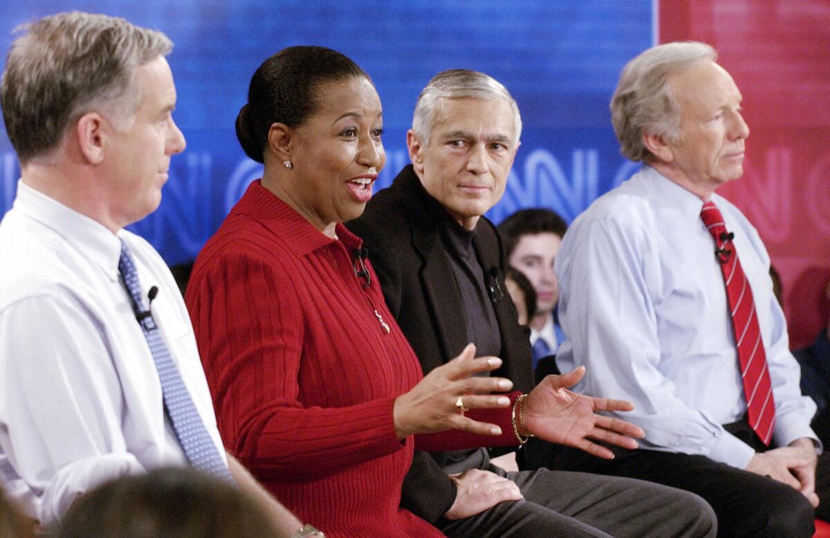 Then-Presidential candidate former senator Carol Moseley Braun (D-IL) (2nd from L) answers a question as Sen. Joe Lieberman (D-CT) (R), former Vermont governor Howard Dean (L), and Retired General Wesley Clark (3rd from L) during a debate sponsored by CNN Rock the Vote at historic Faneuil Hall November 4, 2003 in Boston, Massachusetts.
