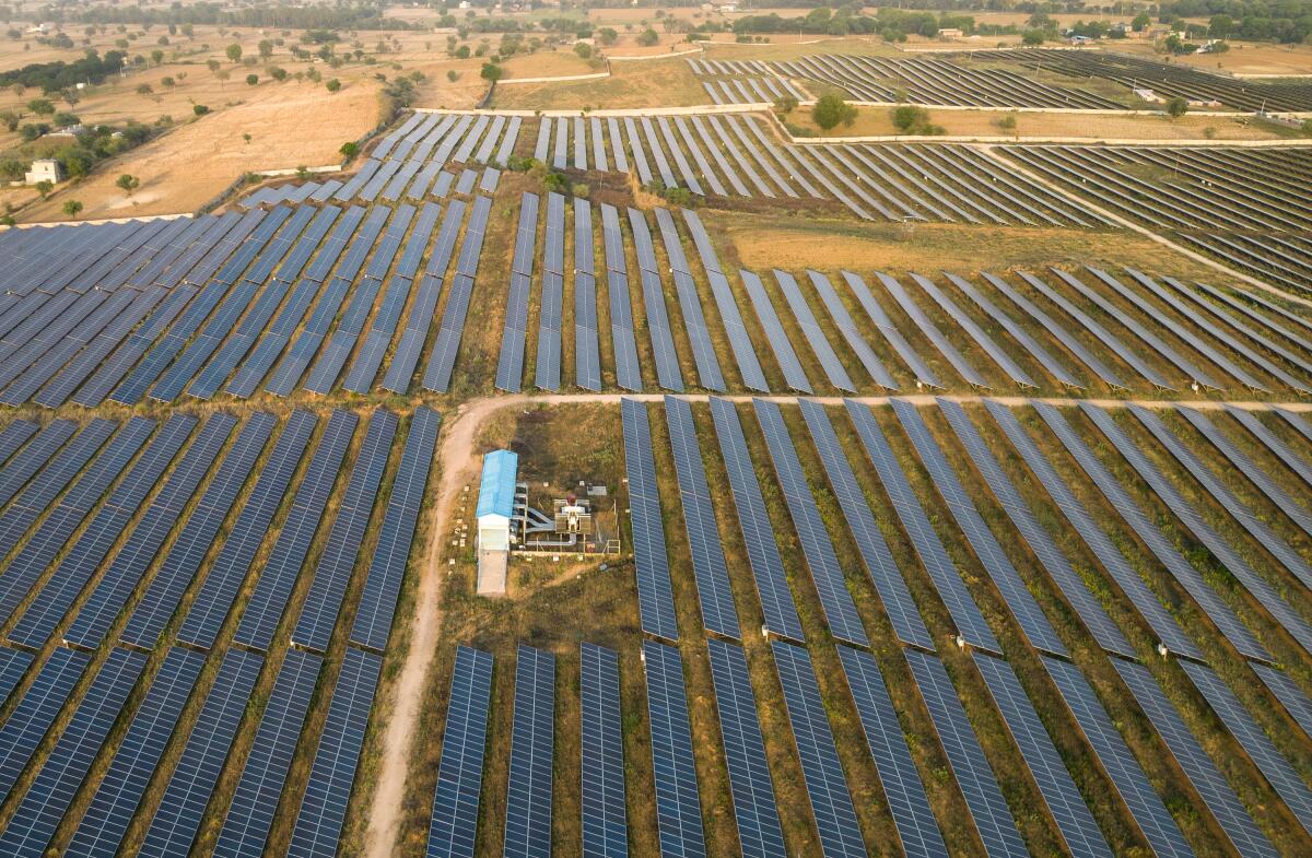An aerial view of solar panels are seen arranged in rows across a solar power plant in Haryana, India. 'What this crisis is doing is kind of creating the need for this energy transition to happen much faster,' says Kaushik Deb who leads the India Team at the University of Chicago's Energy Policy Institute.
