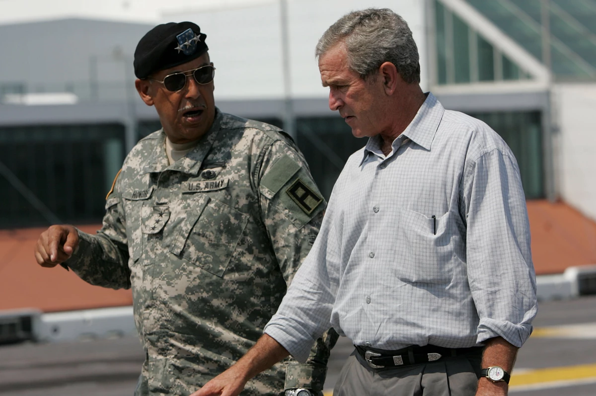 Then-U.S. President George W. Bush talks with then-U.S. Army Lt. Gen. Russel Honoré on the flight deck of the USS Iwo Jima on Sept. 20, 2005, in New Orleans, La.