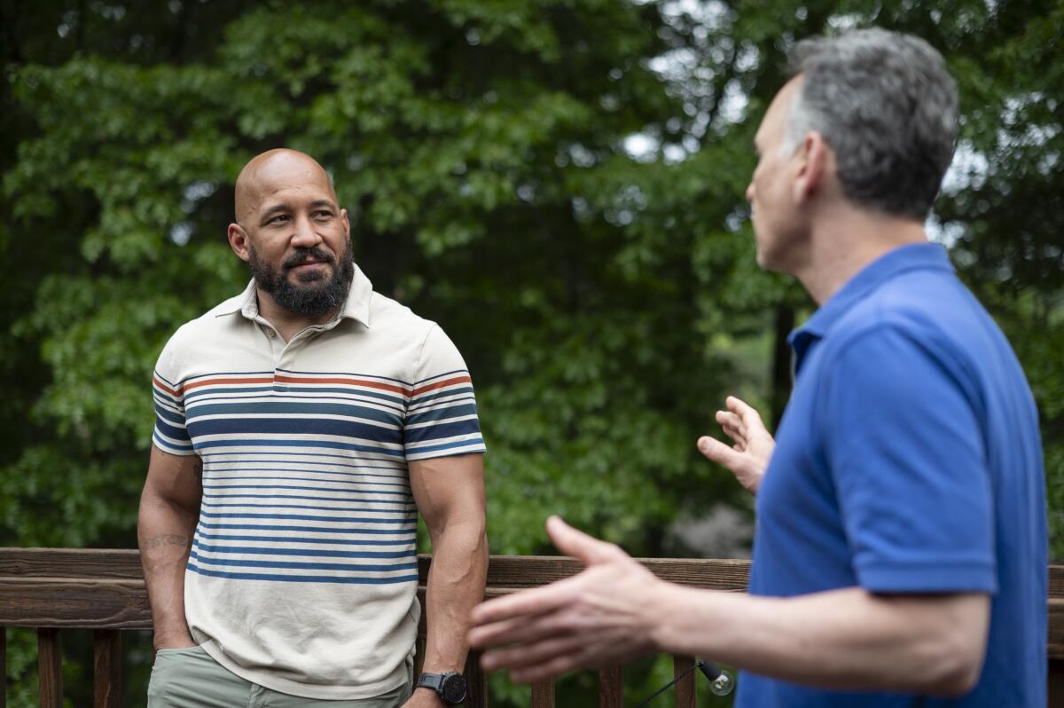 Dave Carlson and NPR Veterans Correspondent Quil Lawrence talk at Carlson's home in Eau Claire, Wis.