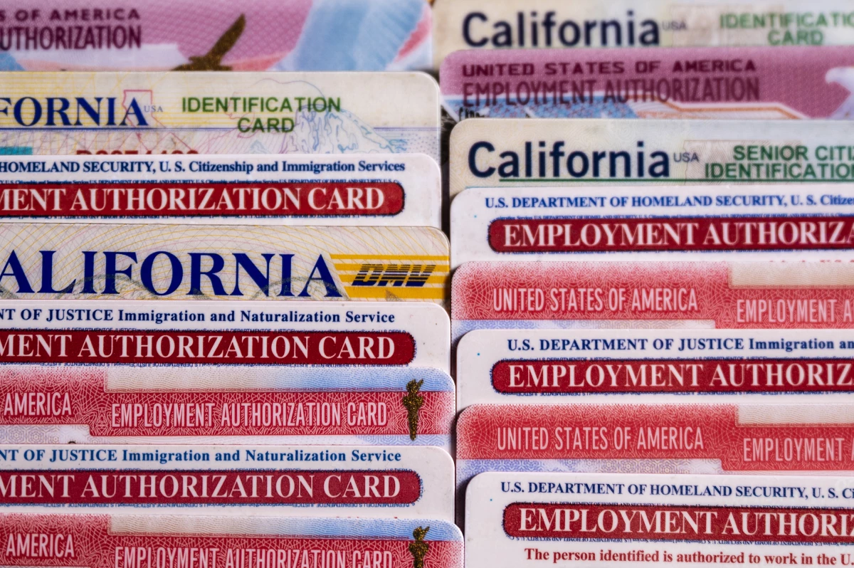 State and federal IDs belonging to Rosa María Carranza, including Social Security, driver's license, and work authorization cards, are displayed on a table at her home in Oakland, California, on Feb. 23, 2026. Carranza, who has lived and worked in the United States for decades with temporary protected status, keeps the cards as a record of her legal authorization to work. (Hiram Alejandro Durán/El Tímpano)