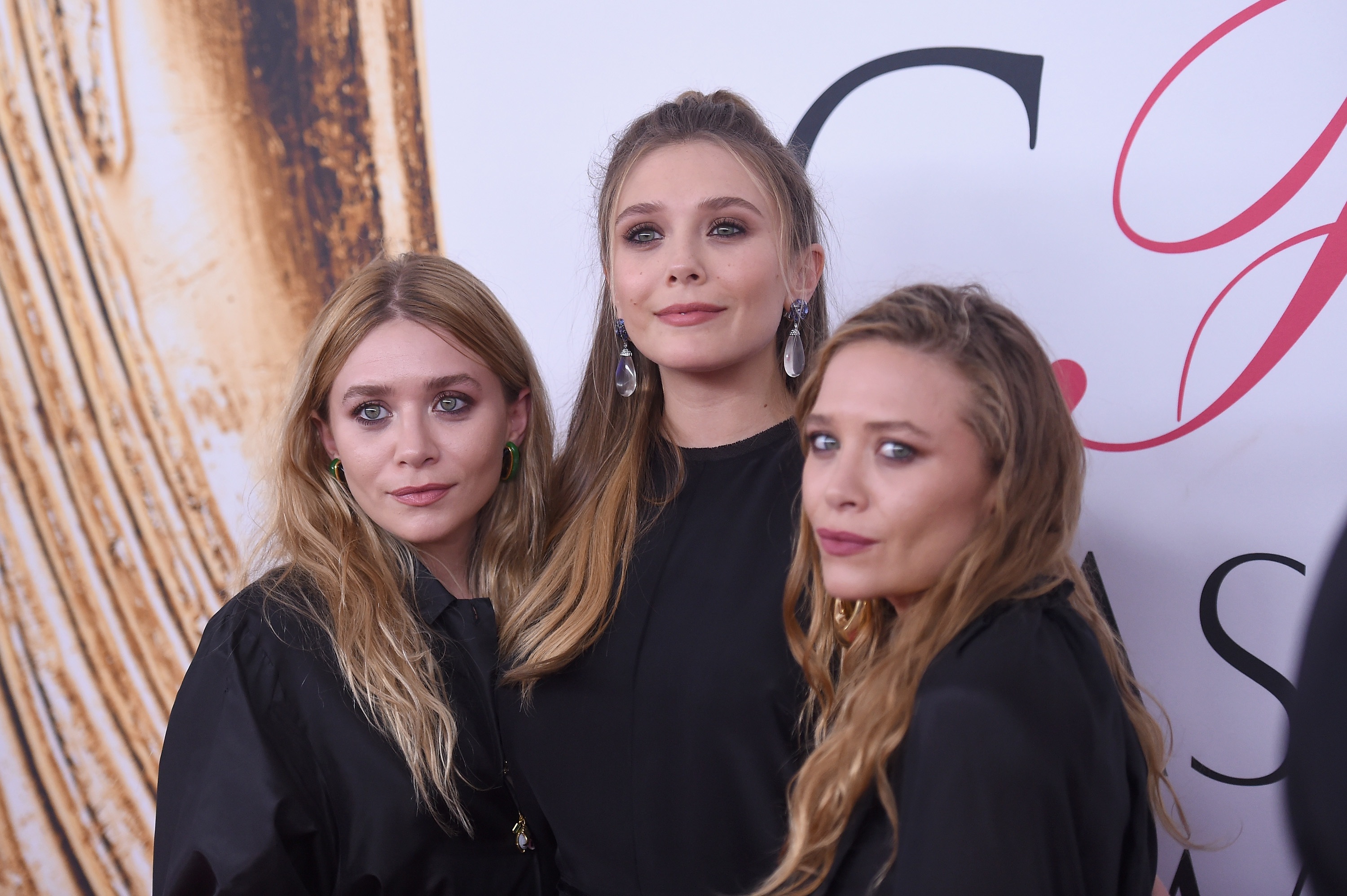 Elizabeth Olsen (center) and Mary-Kate and Ashley Olsen attend the 2016 CFDA Fashion Awards at the Hammerstein Ballroom in June 2016 in New York City.