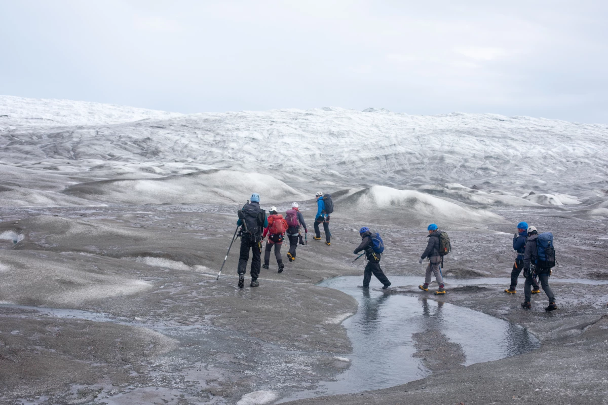 A group of scientists from the United Kingdom trek up to a research site on the west side of the Greenland ice sheet near Kangerlussuaq. This year marks the 29th year in a row that Greenland has lost more ice than it gained.