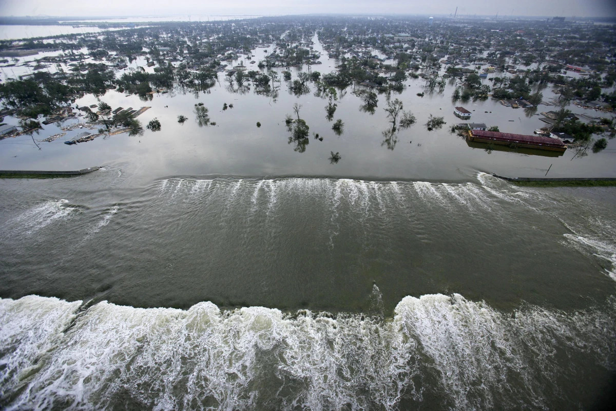 Water spills over a levee along the Inner Harbor Navigation Canal in the aftermath of Hurricane Katrina on Aug. 30, 2005 in New Orleans. It is estimated that 80% of New Orleans is under flood waters as levees begin to break and leak around Lake Pontchartrain.