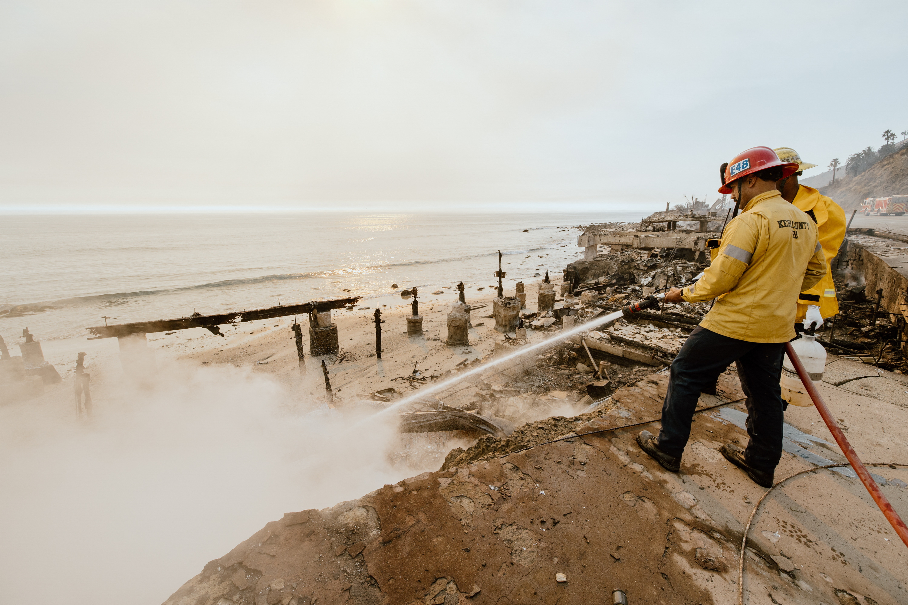 Archive image showing wildfire response in coastal Southern California Firefighter working near damaged coastal infrastructure after an earlier Southern California wildfire; archive photo, not the Bryson Fire