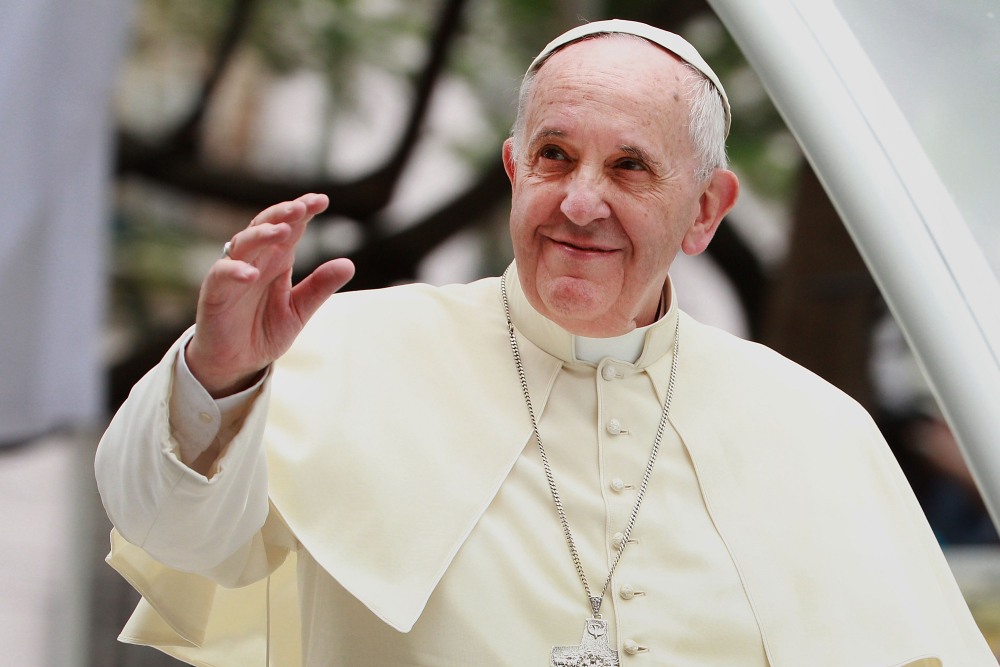 Pope Francis waves to thousands of followers as he arrives at the Manila Cathedral on January 16, 2015 in Manila, Philippines. (Getty Images)