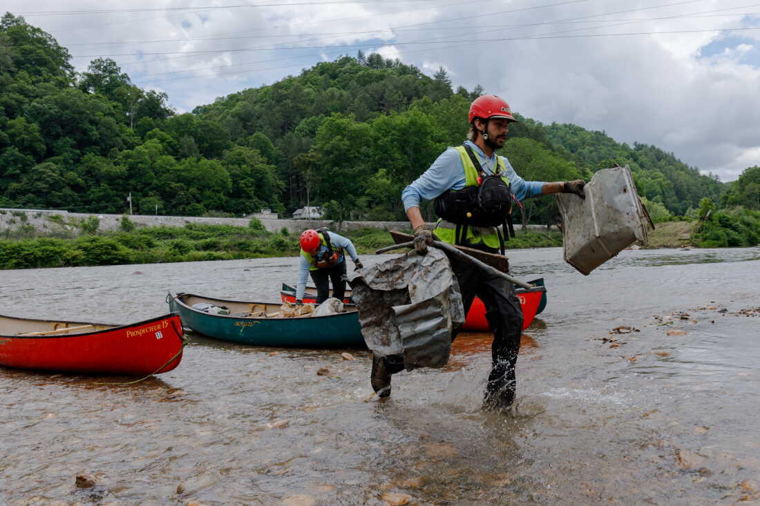Hayden Cheek cleans debris out of the North Toe River in Western North Carolina.