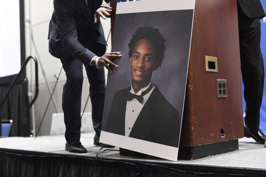 A man places a photograph of Nolan Xavier Wells in front of the podium before a news conference during the 117th NAACP National Convention at McCormick Place in Chicago, Illinois, on July 22, 2026. Wells, an 18-year-old Mississippi college student, was found dead after a boat trip with friends on July 4.
