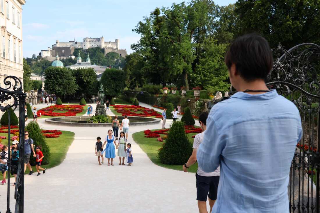 A Chinese family poses in the Mirabell Gardens in Salzburg, Austria, dressed in dirndls and lederhosen.