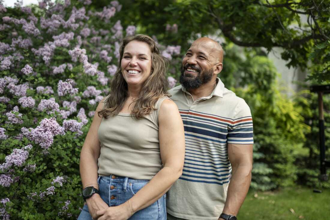 Alicia and Dave Carlson pose for a portrait in their home in Eau Claire, Wis., where they are raising three children.