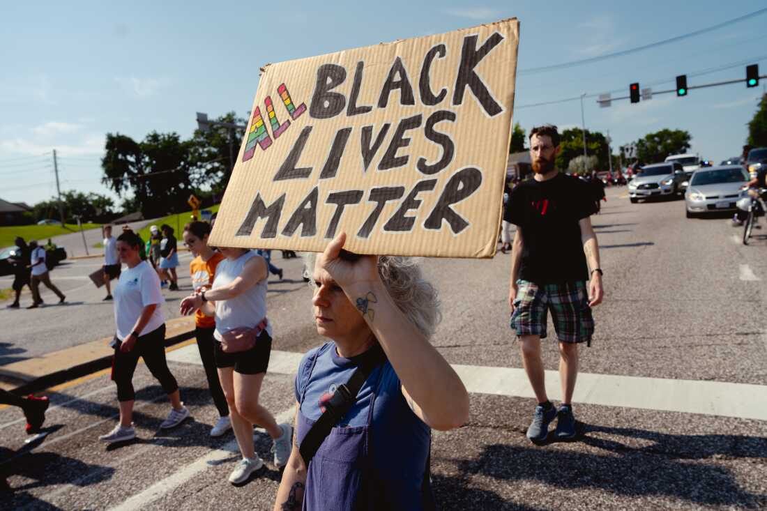 Angelique Kidd, 51, of Ferguson, protests on Friday, Aug. 9, 2024, during a unity march commemorating a decade after Michael Brown Jr.’s police killing in Ferguson.