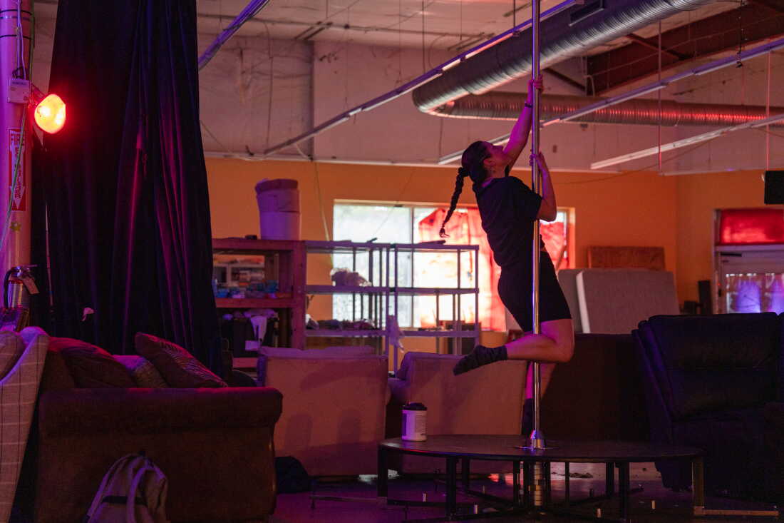 Diana Ledet plays around on a pole at the New Orleans Free Store, in the lower ninth ward of New Orleans, La. on their free skate night on Aug. 19, 2026.